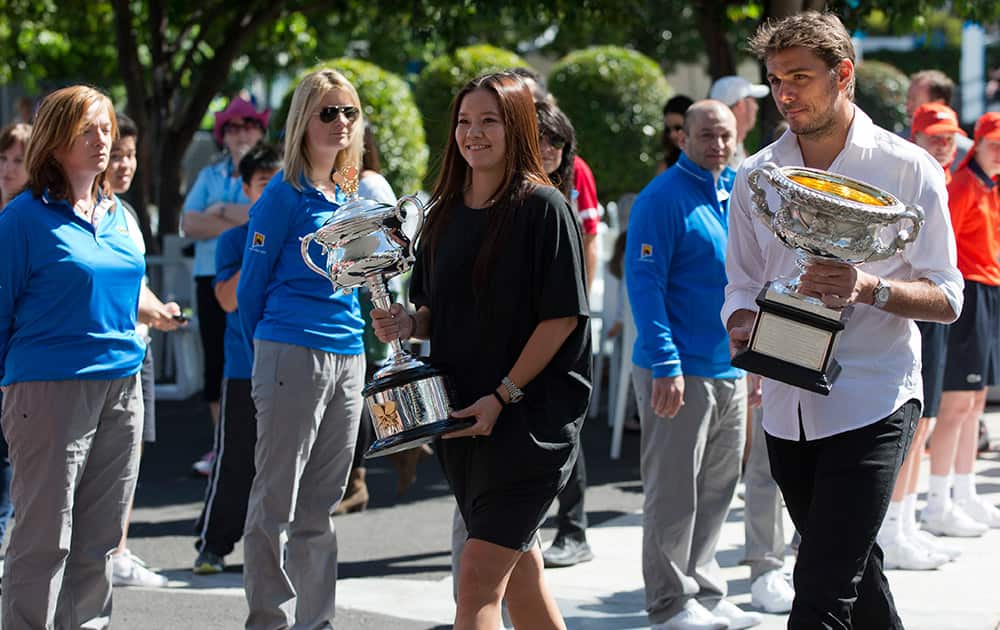 Australian Open champions of 2014 China's Li Na and Switzerland's Stanislas Wawrinka arrive at Melbourne Park for the official draw ceremony ahead of the Australian Open tennis championship in Melbourne.