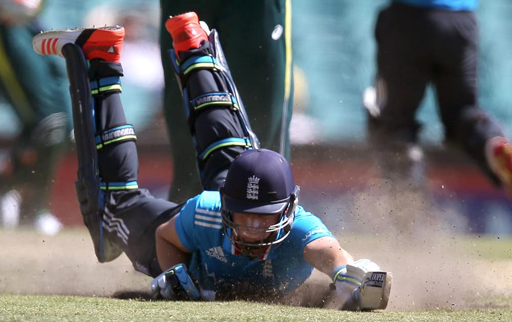 England's Jos Butler dives to make his ground while batting against Australia during their One Day International cricket match in Sydney.