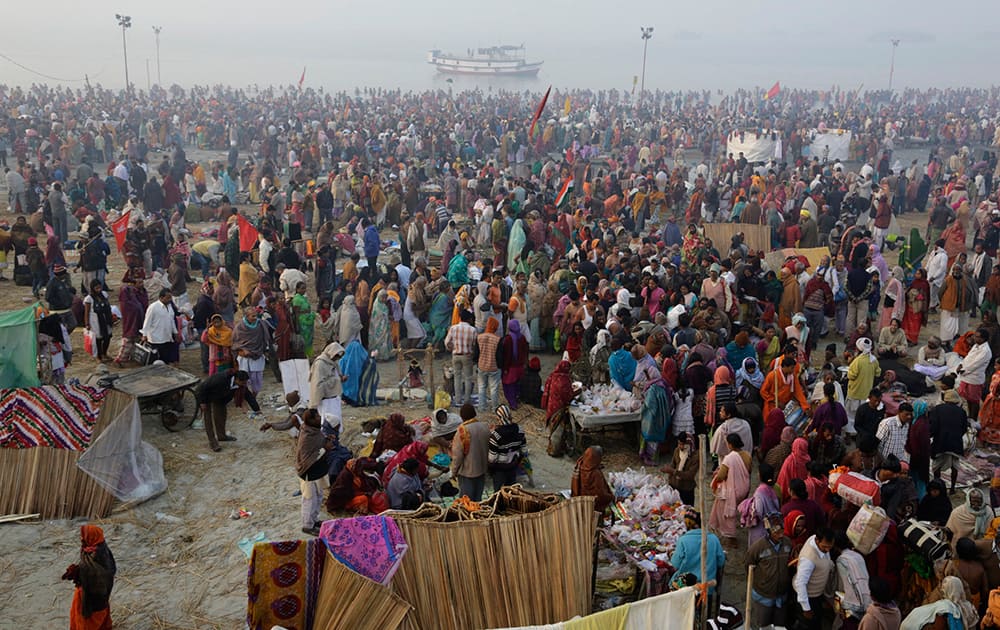 Hindu pilgrims gather on the banks to take holy dips to mark Makar Sankranti festival in Gangasagar.