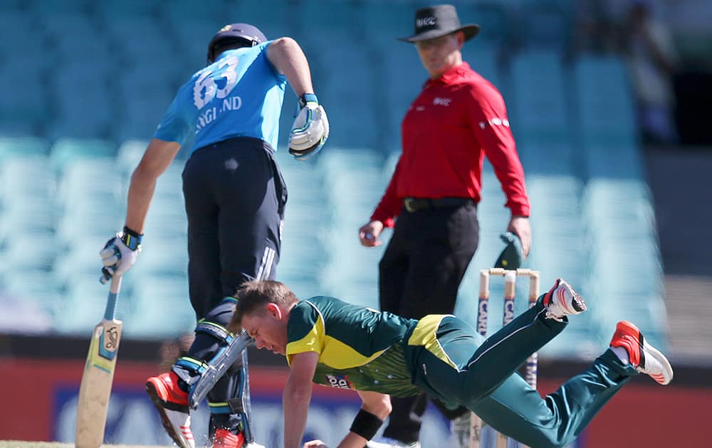 Australia's Xavier Doherty, fields the ball off his own bowling against England during their One Day International cricket match in Sydney.