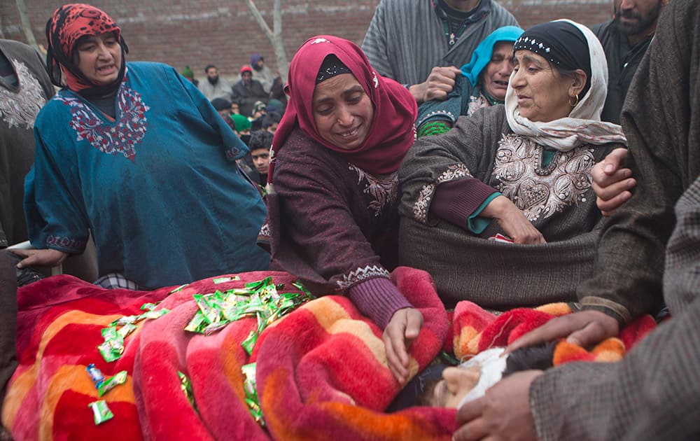 Unidentified women grieve as the body of Ishfaq Ahmed Malik, a suspected local militant, is displayed to the public during his funeral procession in Arwani, some 55 kilometers (35 miles) south of Srinagar.