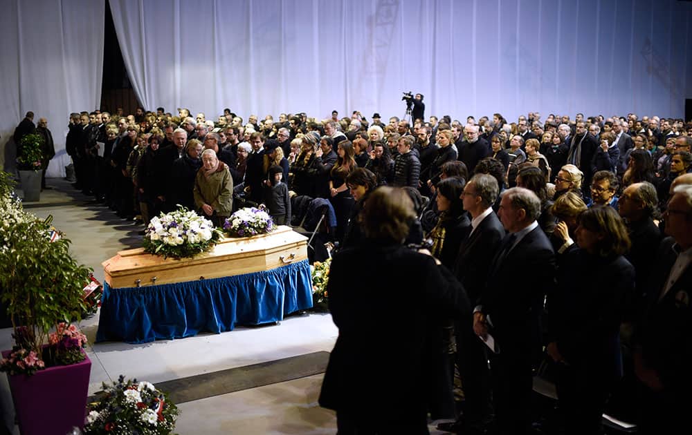 People attend the funeral ceremony of Stephane Charbonnier also known as Charb, the publishing director of Charlie Hebdo, in Pontoise, outside Paris.
