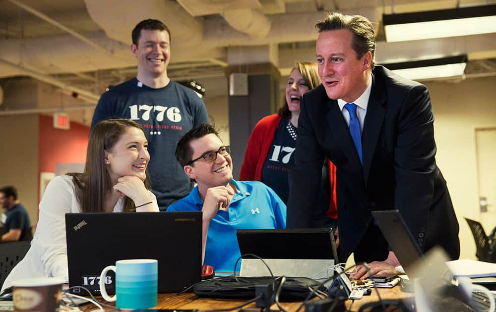 British Prime Minister David Cameron talks with people working at ‘1776’, a hub for tech startups, in Washington, before his meeting with President Barack Obama at the White House. 