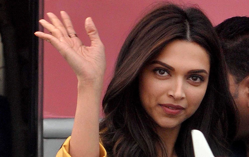 Deepika Padukone waves to her fans during shooting of her new film Tamasha in front of old Kolkata Airport terminal.