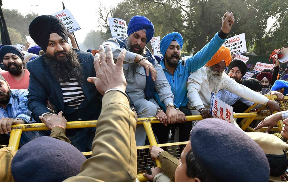 Police stop DSGMC supporters during a protest against the film MSG in New Delhi.