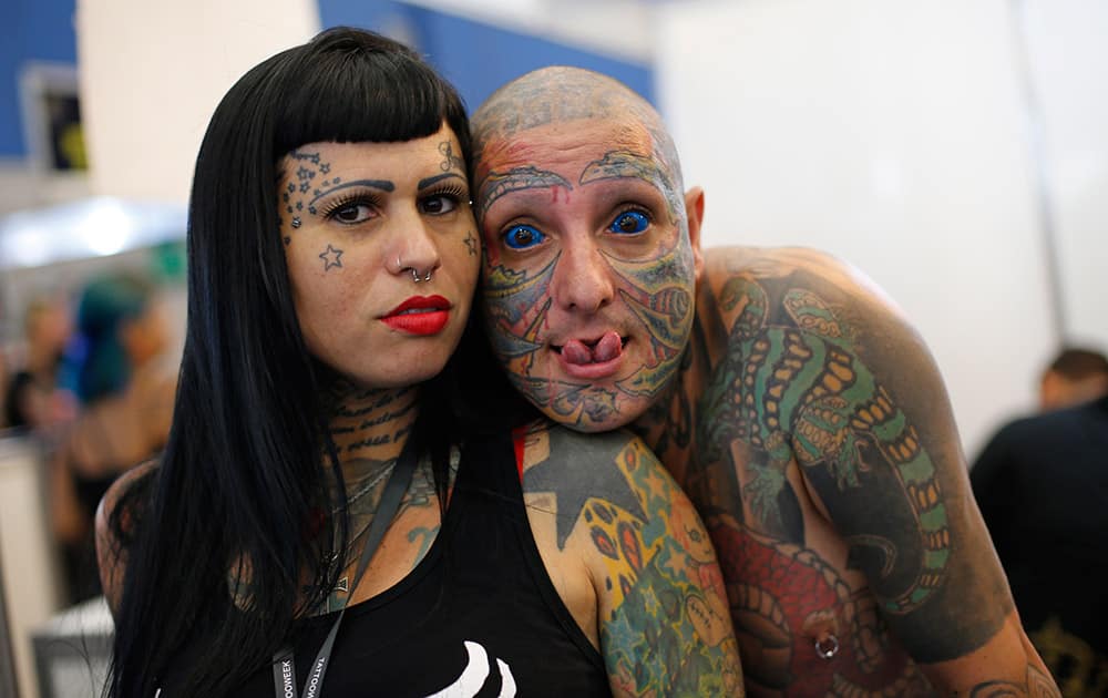 Totolinha and Rato pose for a photo during Rio Tattoo Week in Rio de Janeiro, Brazil. Tattoo artists from Brazil and around the world gathered for the annual three day convention.