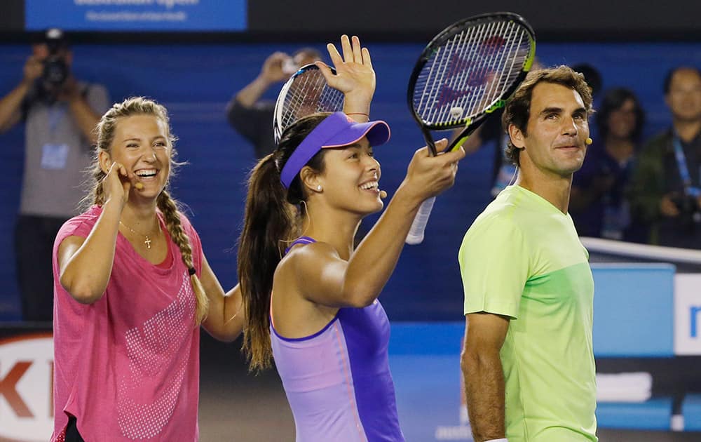 Victoria Azarenka of Belarus, left, Ana Ivanovic of Serbia and Switzerland's Roger Federer celebrate after winning their team event at the Kids Tennis Day on Rod Laver Arena ahead of the Australian Open tennis championship in Melbourne, Australia.