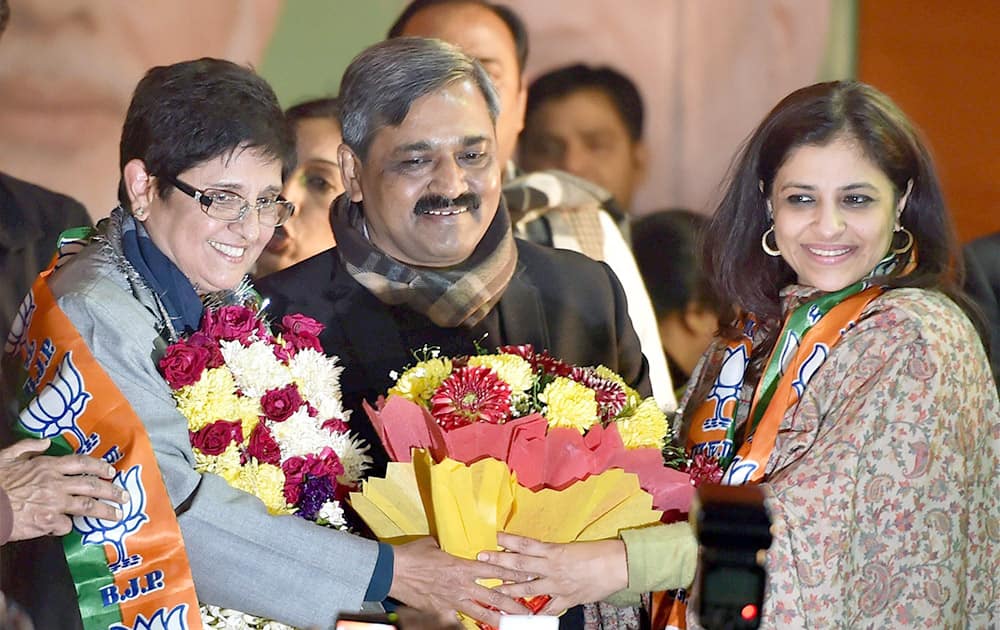 Delhi BJP President Satish Upadhyay greet newly joined BJP leaders Kiran Bedi and Shazia Ilmi during a felicitation function at Delhi BJP office in New Delhi.