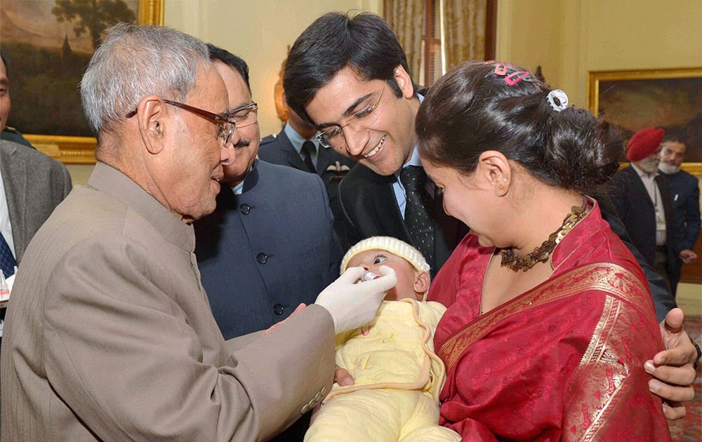 President Pranab Mukherjee administering polio drops to a child to launch the Pulse Polio programme at Rashtrapati Bhavan.