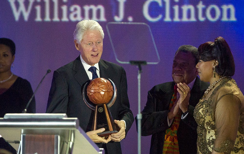 Bill Clinton receives the Salute to Greatness Award as Andrew Young and Bernice King, right, look on, presented by the King Center in Atlanta. 