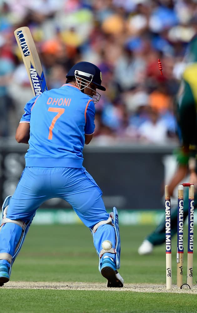 India's MS Dhoni looks at the stumps after being bowled by Australia's Mitchell Starc during their One Day International cricket match in Melbourne, Sunday.