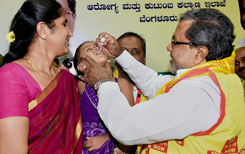 Karnataka chief minister Siddaramaiah gives a dose of pulse polio immunisation to a child at his official residence in Bengaluru.