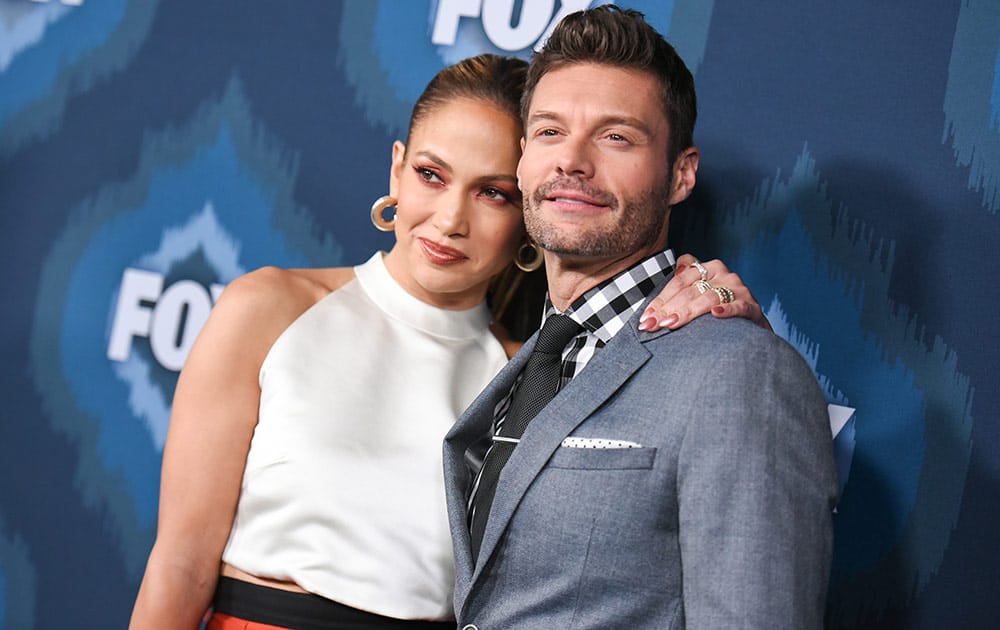 Jennifer Lopez, left, and Ryan Seacrest arrive at the Fox Winter TCA All Star Party in Pasadena, Calif.