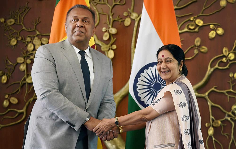 India's Foreign Minister Sushma Swaraj, right, poses with her Sri Lankan counterpart Mangala Samaraweera in New Delhi, India, Sunday. Samaraweera is on a three-day official visit to the country.