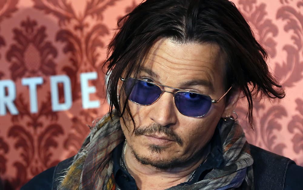 US actor Johnny Depp poses for the photographers during a photocall for the movie 'Mortdecai' in Berlin, Germany, Sunday.