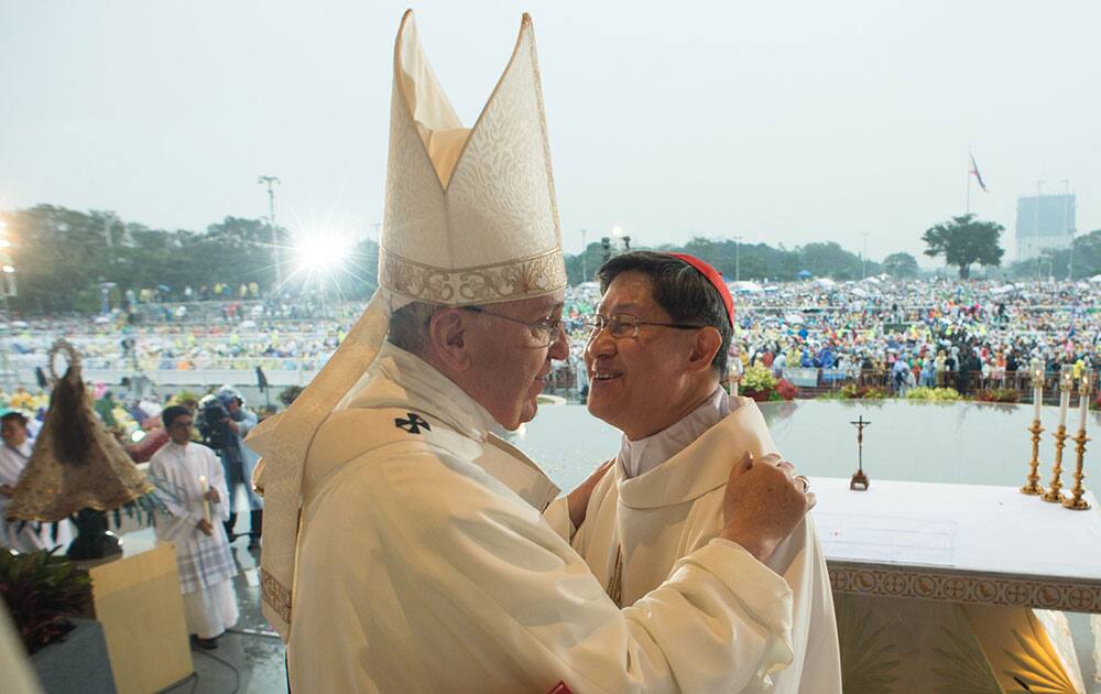 Pope Francis greets Cardinal Luis Antonio Tagle at Rizal Park, in Manila, Philippines.
