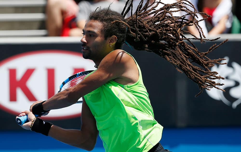 Dustin Brown of Germany's hair flies up as he plays Grigor Dimitrov of Bulgaria during their first round match at the Australian Open tennis championship in Melbourne.