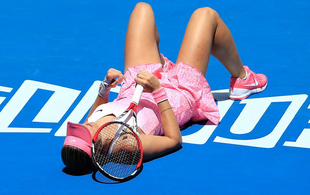 Lucie Hradecka of the Czech Republic lays on the court as she plays Ana Ivanovic of Serbia during their first round match at the Australian Open tennis championship in Melbourne.