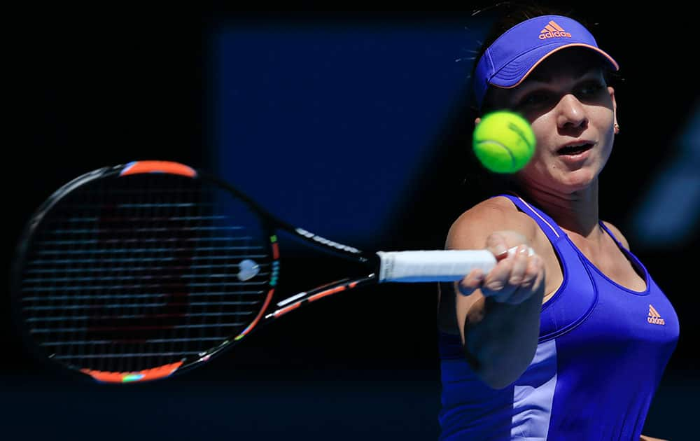 Simona Halep of Romania makes a forehand return to Karin Knapp of Italy during their first round match at the Australian Open tennis championship in Melbourne.