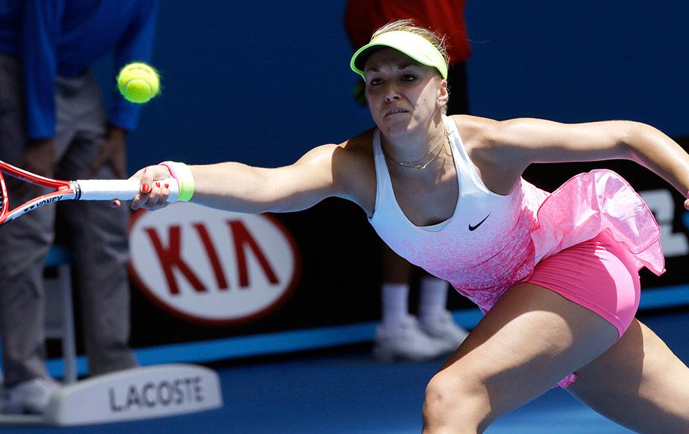 Sabine Lisicki of Germany stretches for a shot to Kristina Mladenovic of France during their first round match at the Australian Open tennis championship in Melbourne.