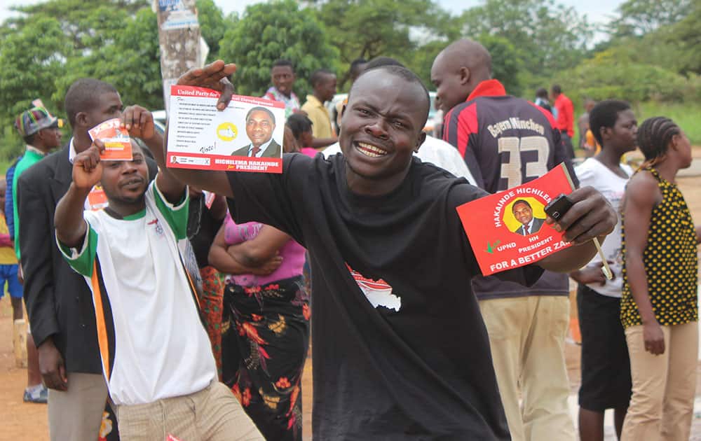 A supporter of Zambia’s leading opposition United Party for National Development (UPND), led by Hakainde Hichilema, shows his campaign leaflets during an election rally in Lusaka.