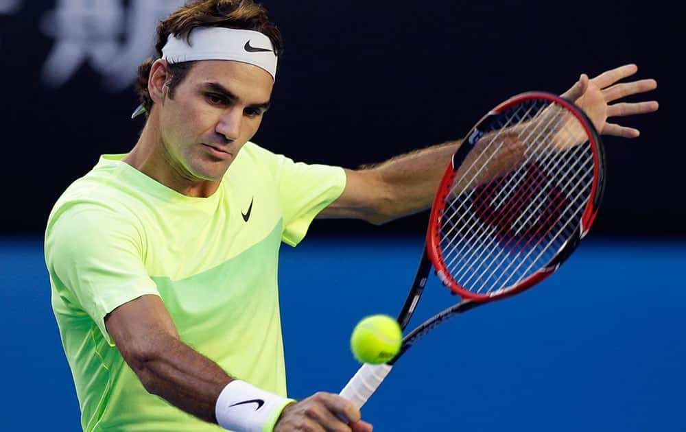 Roger Federer of Switzerland makes a backhand return to Lu Yen-Hsun of Taiwan during their first round match at the Australian Open tennis championship in Melbourne.