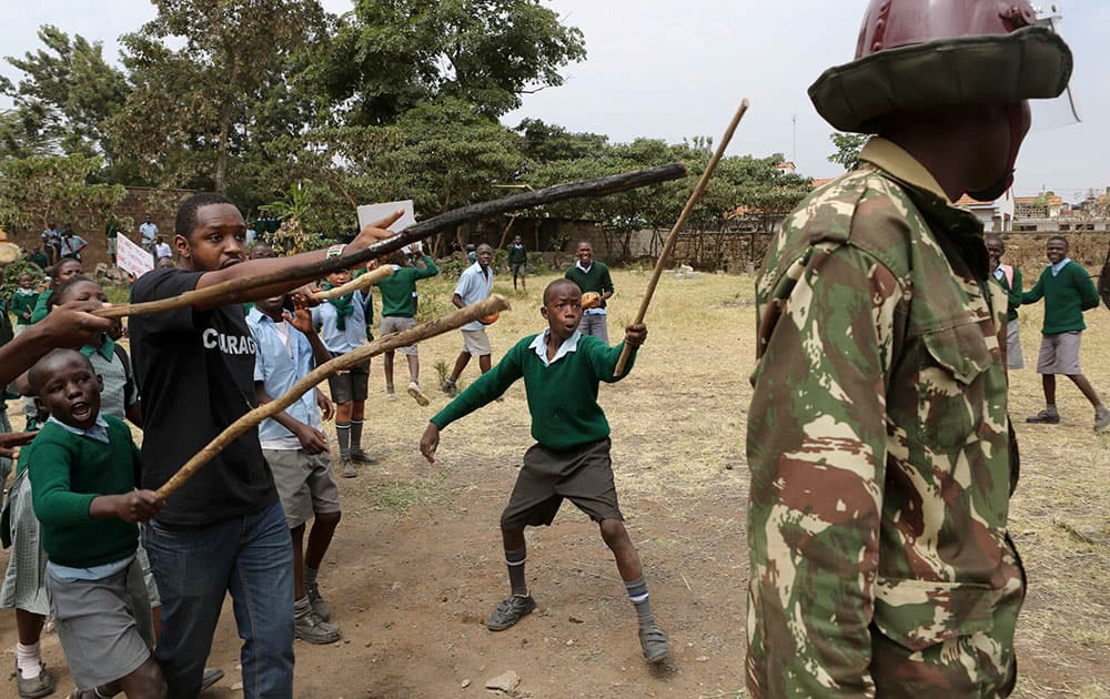Kenyan school pupils and activists challenge riot police during a protest against the removal of their school's playground, at the Langata Road Primary School, in Nairobi, Kenya.