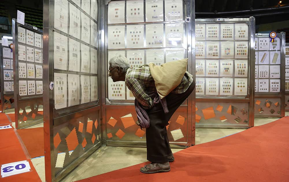 A visitor keenly browses through the exhibits of stamps and other postal material at Karnapex 2015 in Bangalore. Karnapex 2015, a philatelic exhibition organized by Indian postal department has more than 15,000 stamps, post cards and other related material from different countries across the world.