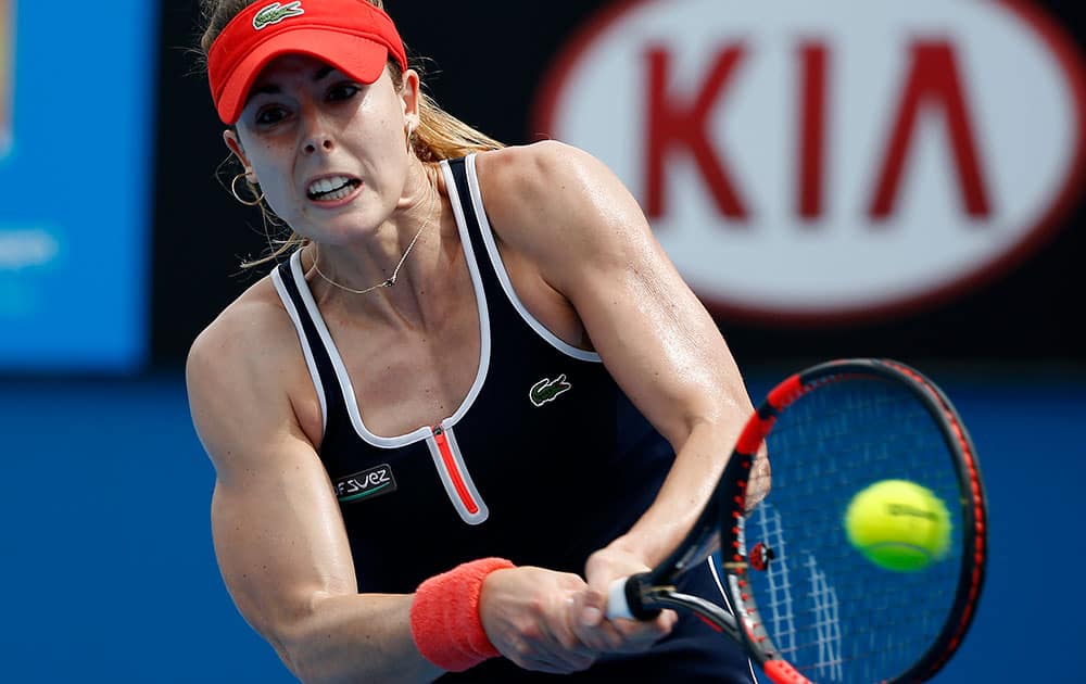 Alize Cornet of France makes a backhand return to Zhang Shuai of China during their first round match at the Australian Open tennis championship in Melbourne.