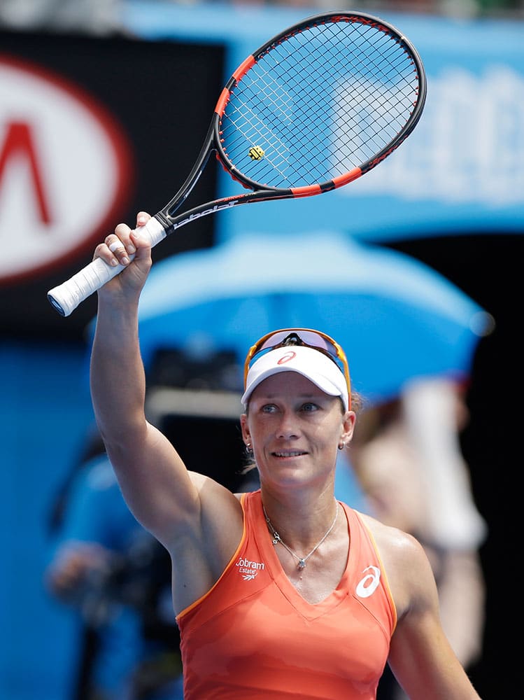 Samantha Stosur of Australia celebrates after beating Monica Niculescu of Romania during their first round match at the Australian Open tennis championship in Melbourne.