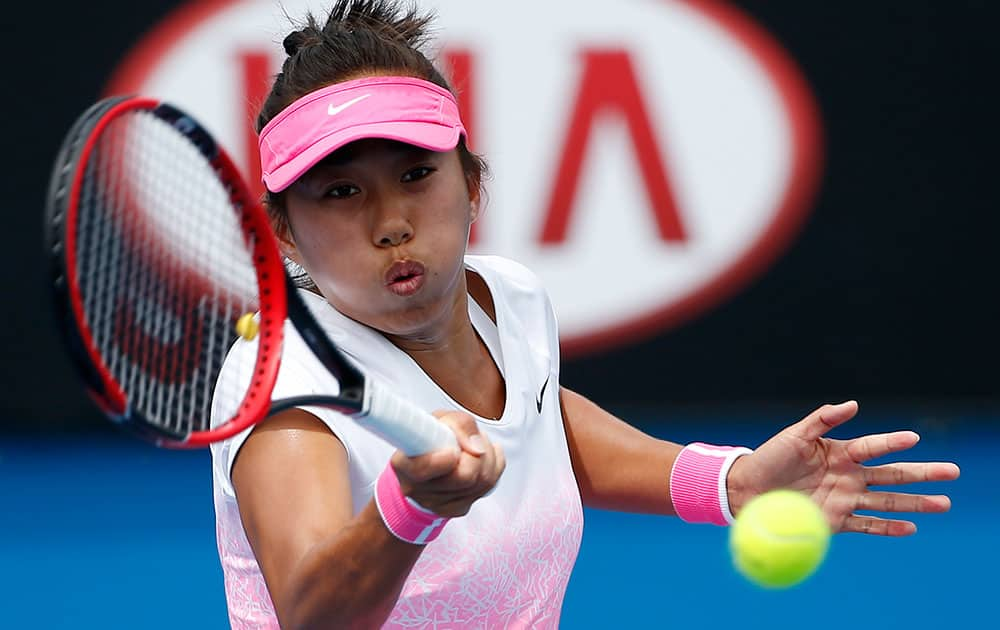 Zhang Shuai of China makes a forehand return to Alize Cornet of France during their first round match at the Australian Open tennis championship in Melbourne.