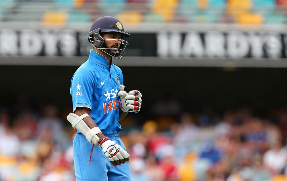 India's Shikhar Dhawan walks off after he is caught behind for 1 run against England during their one day International cricket match in Brisbane.