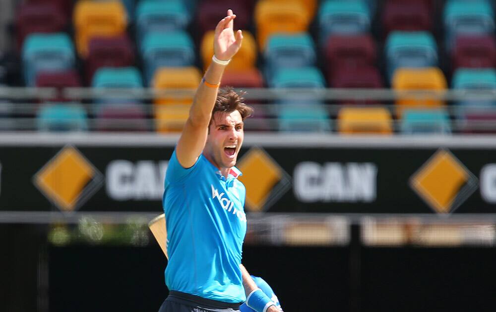 England's Steven Finn celebrates taking the wicket of Ambati Rayudu for 23 runs during their one day International cricket match in Brisbane, Australia.