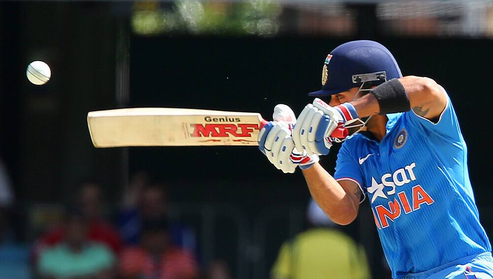 Virat Kohli nicks the ball that has him caught behind for 4 runs against England during their one day International cricket match in Brisbane, Australia.