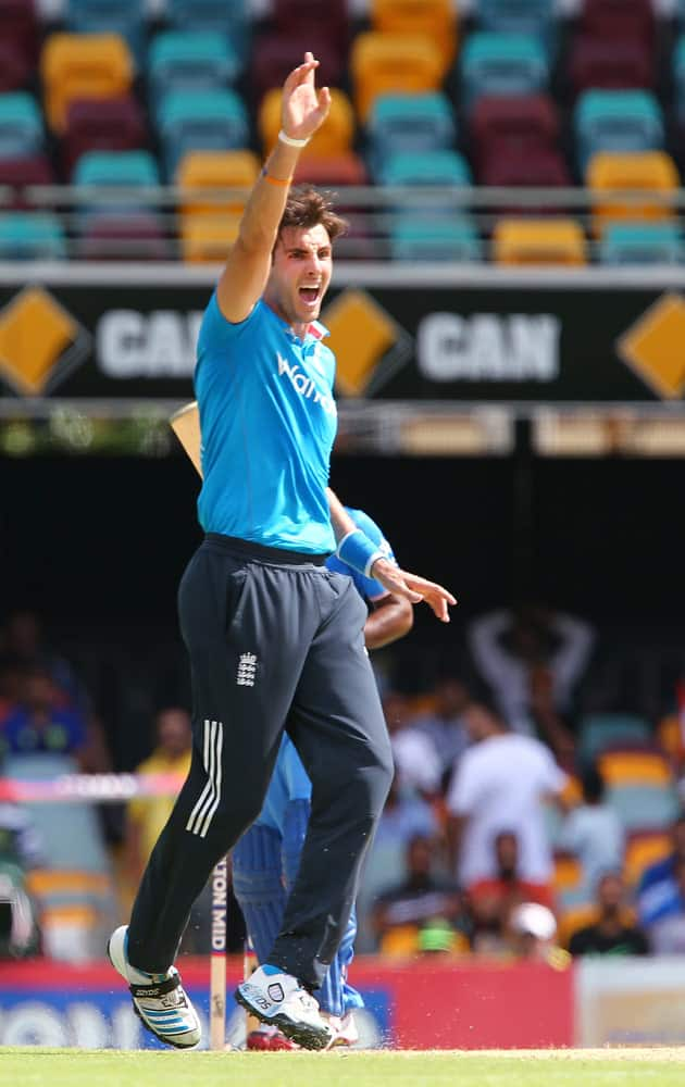 England's Steven Finn celebrates taking the wicket of India's Ambati Rayudu for 23 runs during their one day International cricket match in Brisbane, Australia.