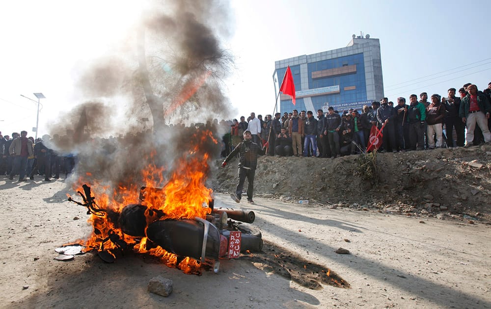 A motorcycle burns after Nepalese demonstrators torched during the general strike called by alliance of 30 party led by Communist Party of Nepal (CPN-Maoist) in Kathmandu, Nepal.