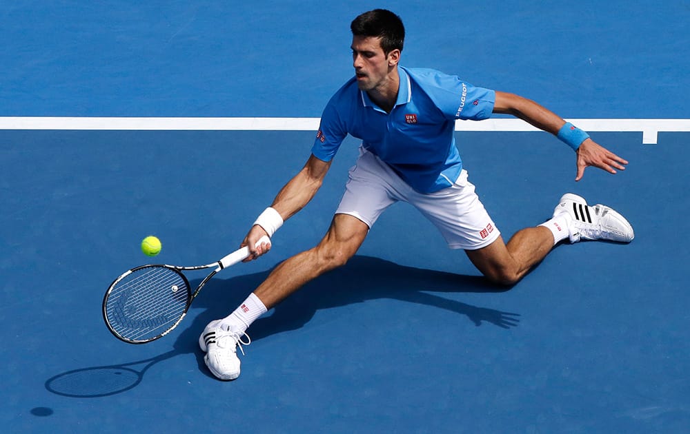 Novak Djokovic of Serbia hits a forehand return to Sloveniais Aljaz Bedene during their first round match at the Australian Open tennis championship in Melbourne.