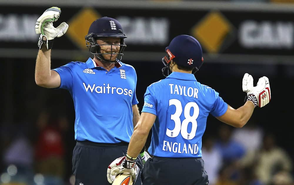 England's Ian Bell, and James Taylor, celebrate after England won the one day International cricket match against India in Brisbane, Australia.