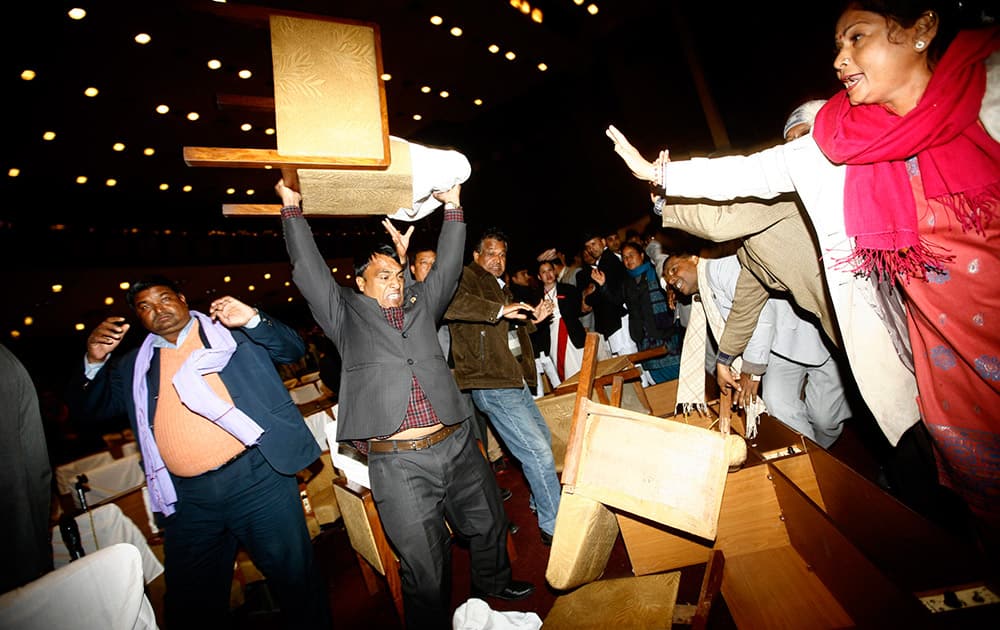 An unidentified Nepalese politician from the opposition party lifts a chair to throw, during the Constituent Assembly meeting, in Kathmandu, Nepal.