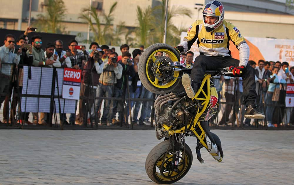 European motorcycle stunt rider Aras Gibieza performs during the India Bike Week (IBW) tour in Ahmadabad.