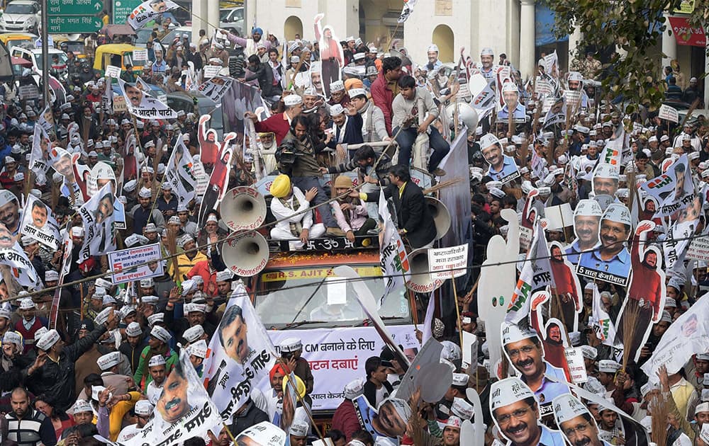 AAP convener Arvind Kejriwal along with his supporters during his election road show in New Delhi.