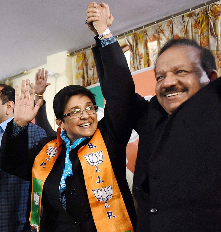 BJP Chief Minister candidate Kiran Bedi with Science and Technology minister Harsh Vardhan during election campaign at Krishna Nagar area in New Delhi.