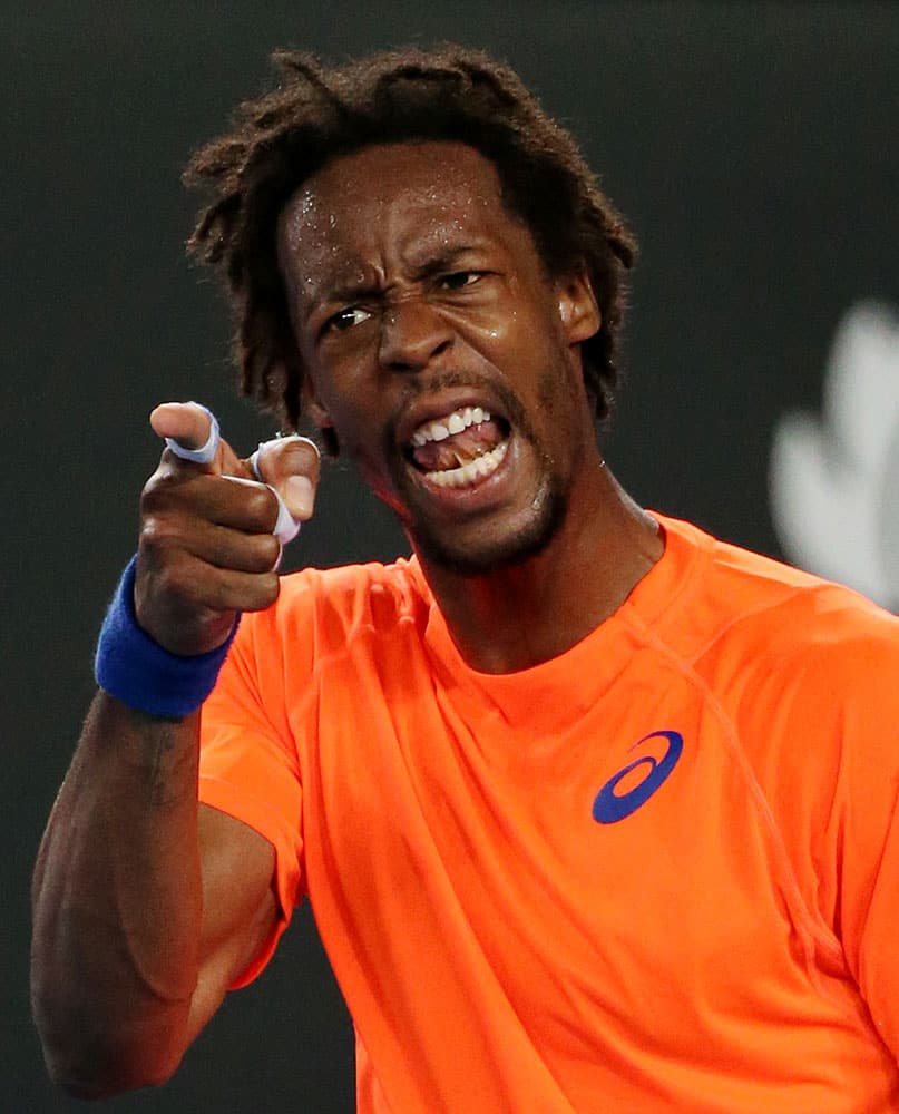 Gael Monfils of France disputes a line call as he plays his compatriot Lucas Pouille during their first round match at the Australian Open tennis championship in Melbourne.