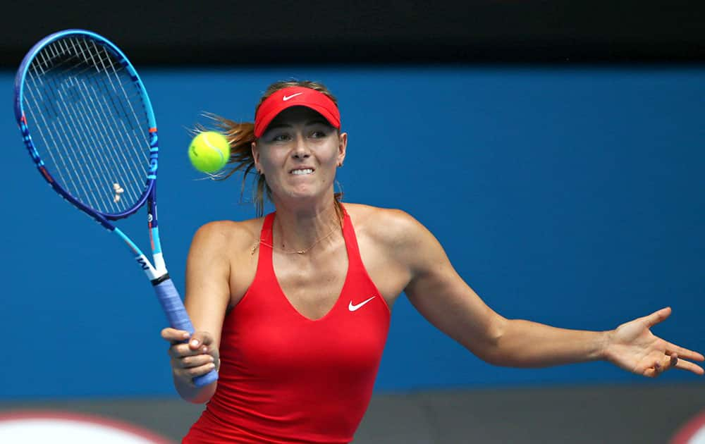 Maria Sharapova of Russia makes a forehand return to Alexandra Panova of Russia during their second round match at the Australian Open tennis championship in Melbourne.