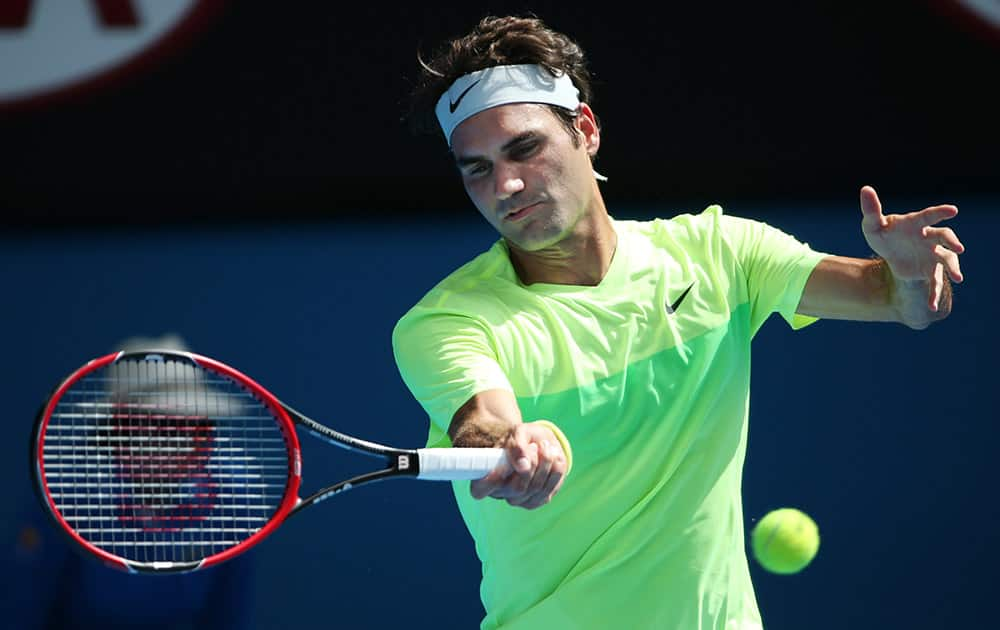 Roger Federer of Switzerland makes a forehand return to Simone Bolelli of Italy during their second round match at the Australian Open tennis championship in Melbourne, Australia.