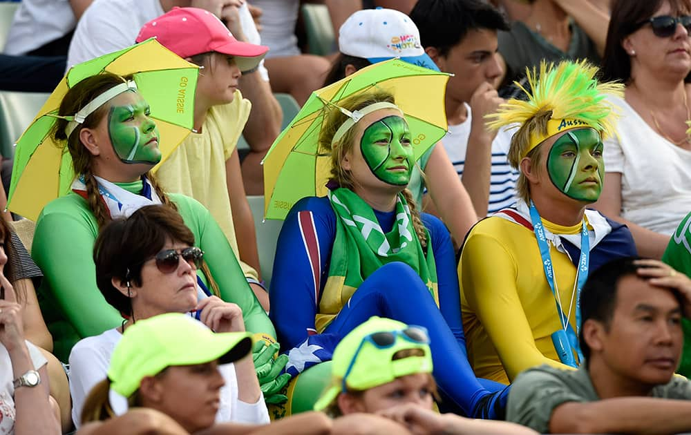 Face painted fans watch the second round match between Nick Kyrgios of Australia and Ivo Karlovic of Croatia at the Australian Open tennis championship in Melbourne.