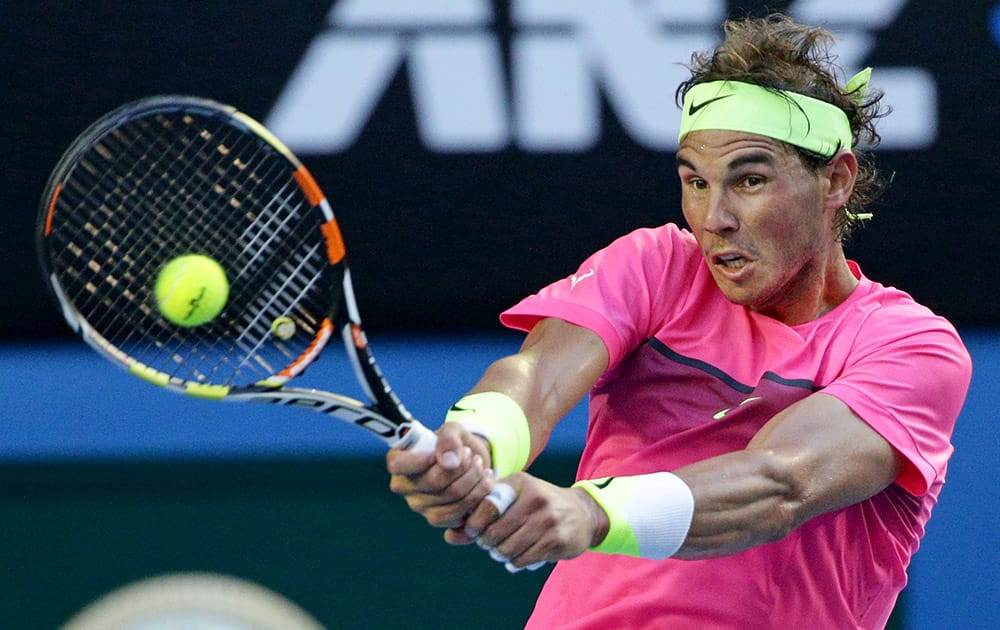 Rafael Nadal of Spain makes a backhand return to Tim Smyczek of the U.S. during their second round match at the Australian Open tennis championship in Melbourne, Australia.