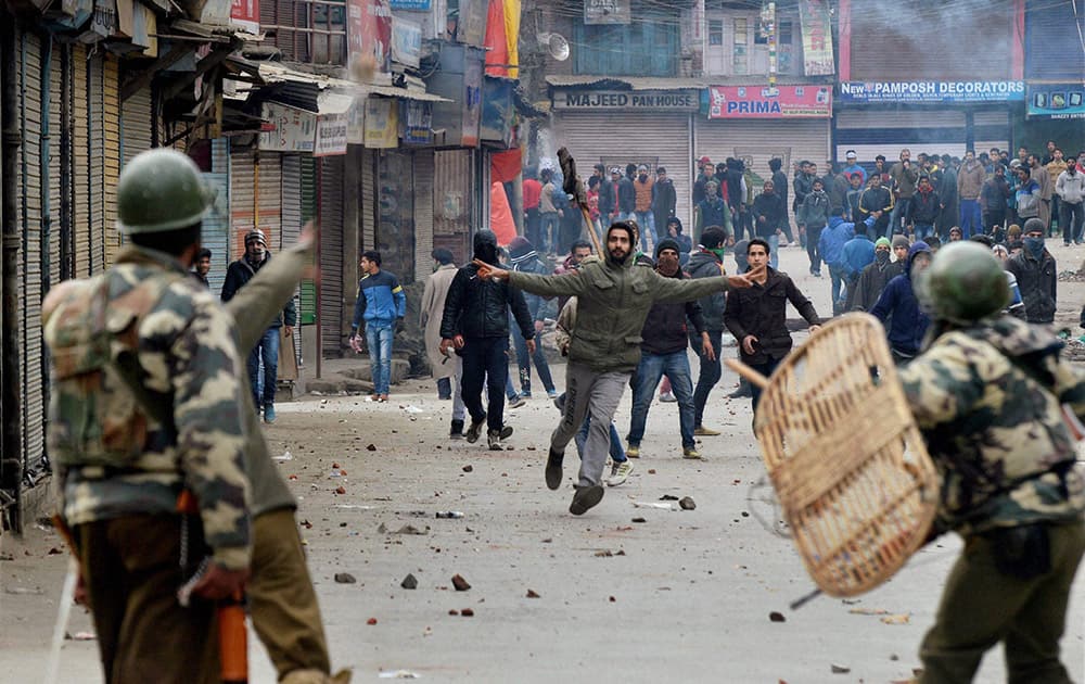Security personnel in action against protesters in Srinagar.