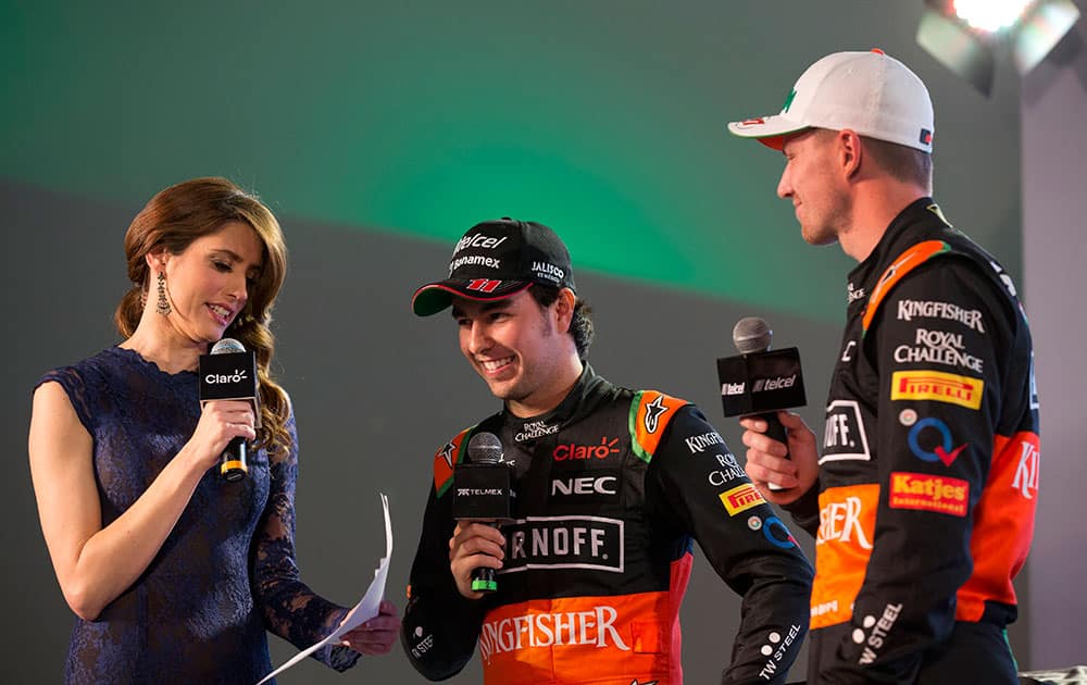 Drivers Sergio Perez, center, and Nico Hulkenberg, right, answer prepared questions from a presenter during a press event to announce the 2015 Sahara Force India Formula One racing team, at the Soumaya Museum in Mexico City.