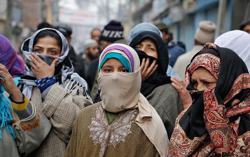 Kashmiri women listen to Yasin Malik as he speaks during a memorial service to mark the anniversary of an alleged massacre in Srinagar, India.